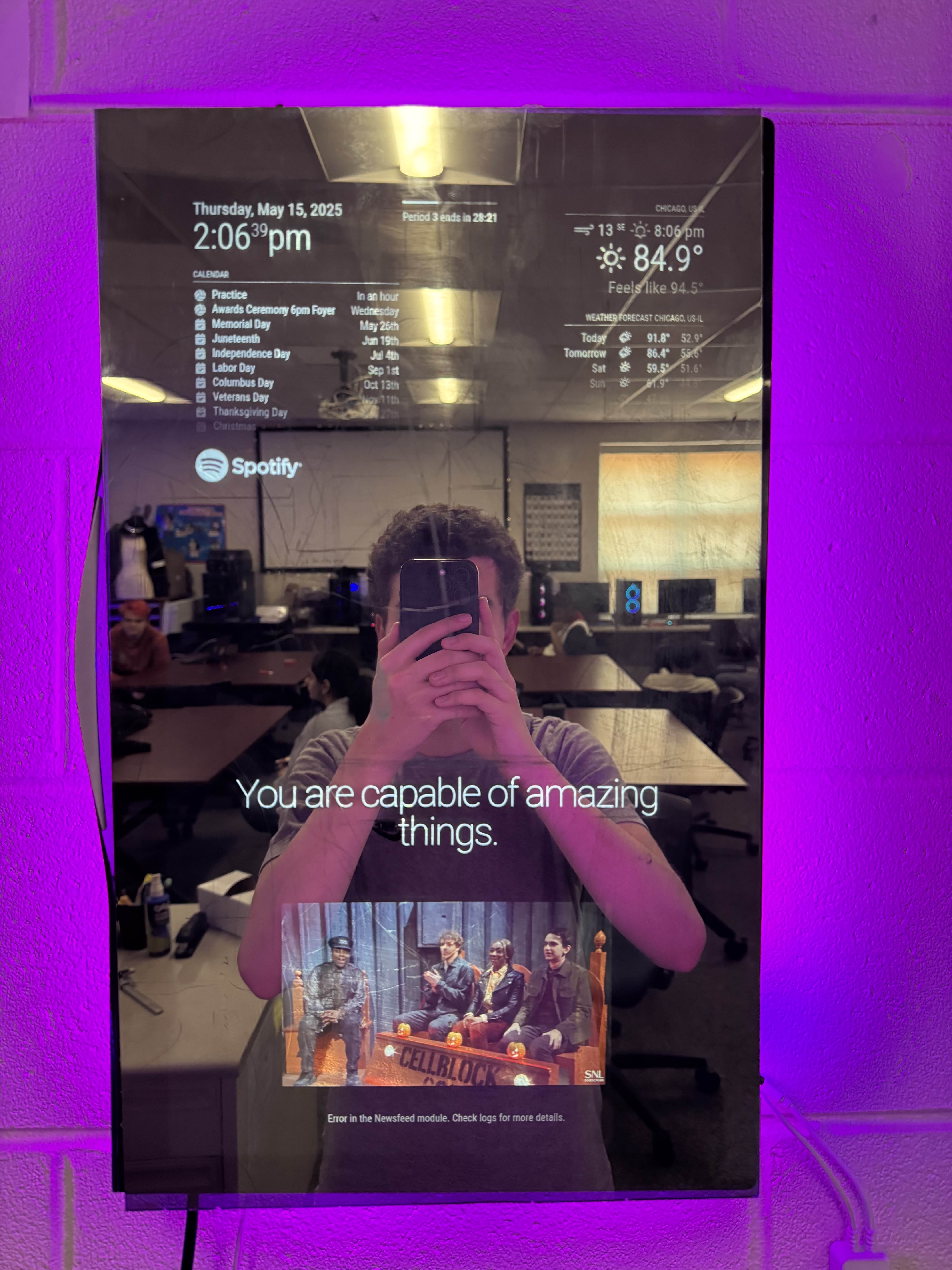 Final mirror with purple ambient lighting, quote and video visible